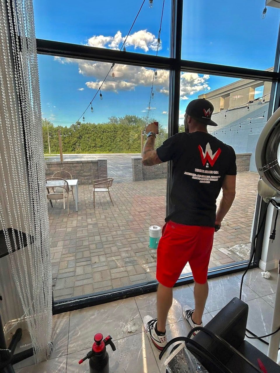 Derek Rassel, CEO of Window Armor, installing window film